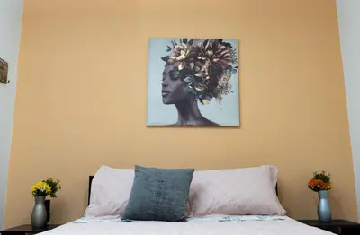 a picture of a woman with a flower on the wall at Hospedaje juandi in Medellín
