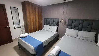 two beds in a small room with two beds sidx sidx sidx at ANDALIVING NIQUIA Apartaestudio in Bello
