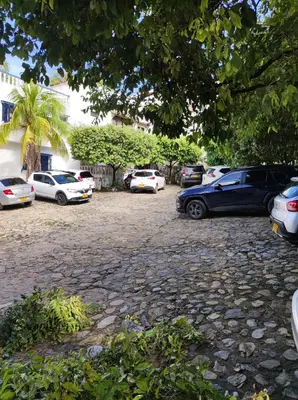 a group of cars parked in a parking lot at Cabaña 41, aldea Doradal Santorini Colombiano in Puerto Triunfo