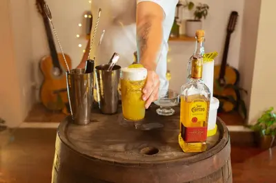 a man standing on a barrel with two bottles of beer at Hotel Colonial Abejorral in Abejorral