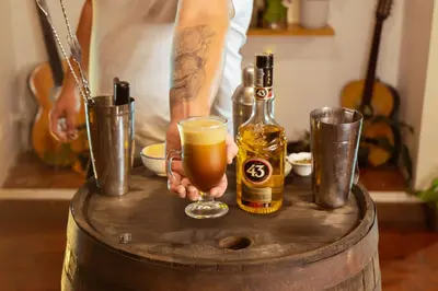 a man holding a glass of beer on a barrel at Hotel Colonial Abejorral in Abejorral
