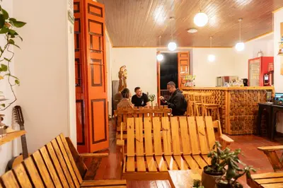 a group of people sitting at a table in a restaurant at Hotel Colonial Abejorral in Abejorral