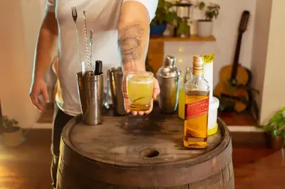a person holding a drink on top of a barrel at Hotel Colonial Abejorral in Abejorral