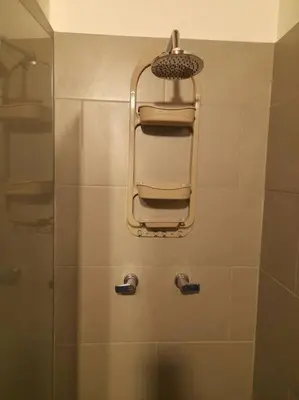 a bathroom with a shower with a shower seat at Tribu Medellin House in Medellín