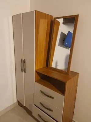 a wooden dresser with a mirror and a cabinet at Tribu Medellin House in Medellín