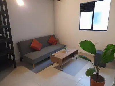 a living room with a couch and a table at Tribu Medellin House in Medellín