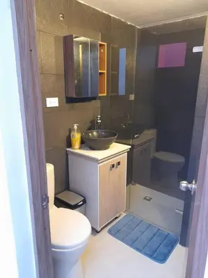 a bathroom with a sink and a toilet and a sink at Tribu Medellin House in Medellín