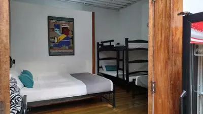 a small room with a bed and a bunk bed at HOTEL GIRASOLES in Manizales