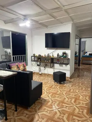 a living room with a couch and a flat screen tv at Los balcones lll in Medellín