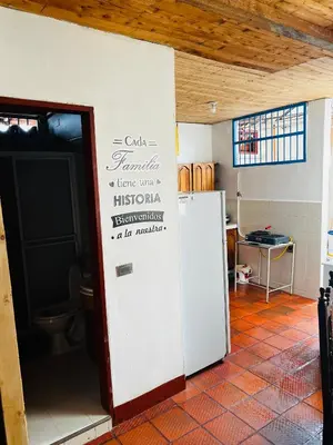 a room with a white refrigerator and a toilet at Casa madera in Jardin