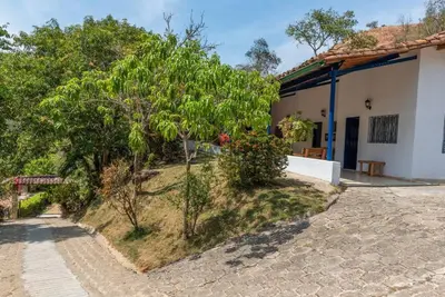 a house with trees on the side of it at Finca La Maria: Recreo y naturaleza (22 personas) in Santa Fe de Antioquia