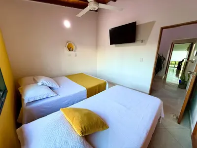 a hotel room with two beds and a television at Sol Apartamentos Doradal in Doradal