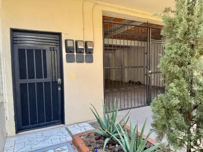 a front door of a building with a gate at Sol Apartamentos Doradal in Doradal