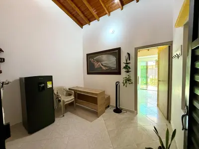 a living room with a refrigerator and a table at Sol Apartamentos Doradal in Doradal