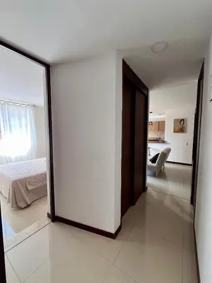 a bedroom with a door leading to a bed at Apartamento Completo Poblado - Ubicacion Central con Parqueadero in Medellín