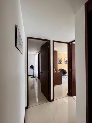 a hallway with two doors leading to a room at Apartamento Completo Poblado - Ubicacion Central con Parqueadero in Medellín