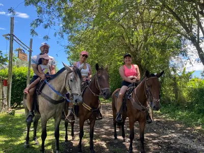 a group of people riding horses on a path at Los Potrillos in Mariquita