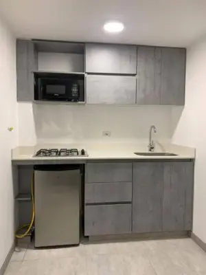 a kitchen with a sink and a stove and a microwave at Apto frente al Malecón, Ubicación fantástica, Vista in Guatapé
