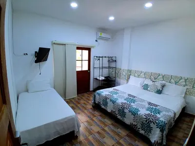 a small bedroom with a bed and a window at Hotel Santa Fe del Parque in Santa Fe de Antioquia