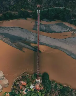 an aerial view of a river with a building in the middle at Hotel Santa Fe del Parque in Santa Fe de Antioquia