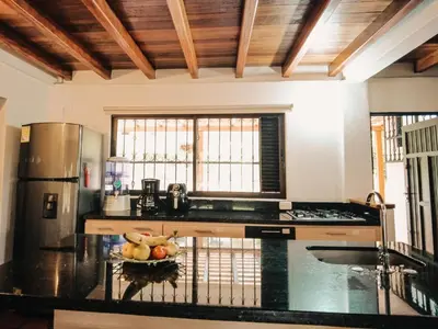 a kitchen with a bowl of fruit on a counter at Volare Guatapé isla de descanso y retiro in Guatapé