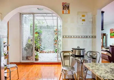 a kitchen with an archway and a table with a pot on it at Nora's Casa de familia Laureles in Medellín