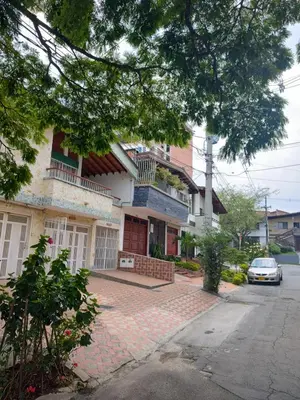 a house with a car parked in front of it at Nora's Casa de familia Laureles in Medellín