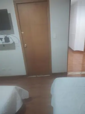 a room with a door and a wooden floor at Nora's Casa de familia Laureles in Medellín
