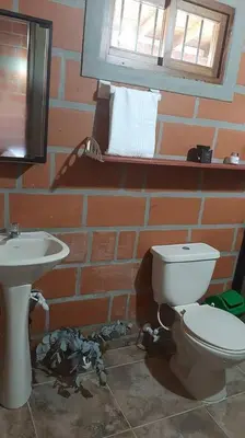 a bathroom with a toilet and a sink at Casa de Campo vía El Peñol Guatapé in Marinilla