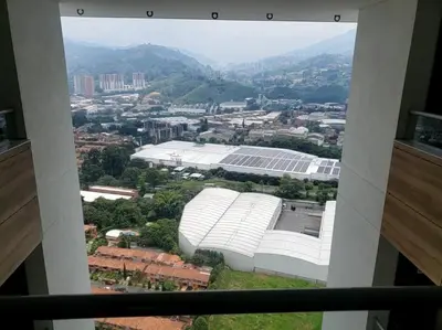 a view of a large white building in a city at Penthouse Lujo Itagui 40 Piso Vista Panoramica Jacuzzi Sauna Largo Plazo in Itagüí