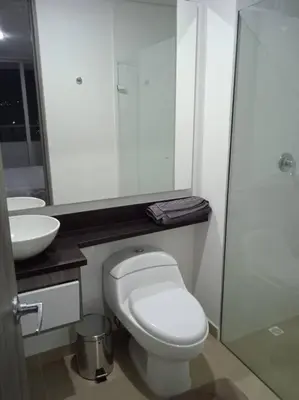 a bathroom with a white toilet and a sink at Penthouse Lujo Itagui 40 Piso Vista Panoramica Jacuzzi Sauna Largo Plazo in Itagüí