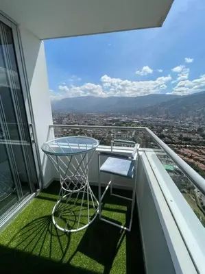 a glass table on the balcony of a building at Penthouse Lujo Itagui 40 Piso Vista Panoramica Jacuzzi Sauna Largo Plazo in Itagüí