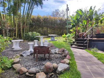 a garden with a fire pit in a yard at Cottage Master Room en Guatapé-Desayuno- Sauna Finlandes in Chiquinquirá