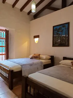 a bedroom with two beds and a window at Recinto Alfaro in Concepción
