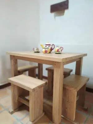 a wooden table with two tea cups on it at Recinto Alfaro in Concepción