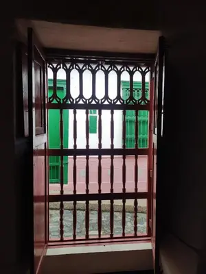 an open window with a view of a building at Recinto Alfaro in Concepción