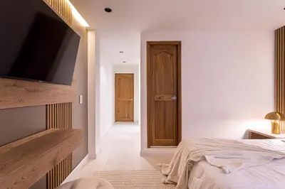 a bedroom with a bed and a flat screen tv at Jacuzzi Privado, Casa de Lujo Norte Medellin in Medellín