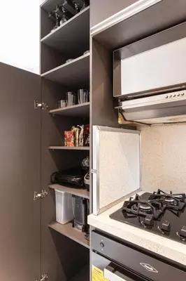 a kitchen with a stove top oven in a kitchen at Cozy Apartment with A/C in North Medellin. in Medellín