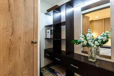 a bathroom with a mirror and a vase with flowers at Cozy Apartment with A/C in North Medellin. in Medellín