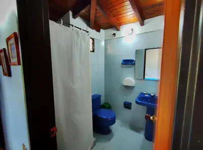 a bathroom with a blue toilet and a sink at Gran Tierra - Sabaneta in Medellín