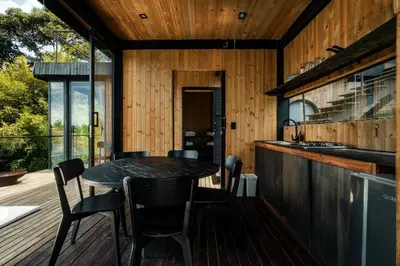 a kitchen with a table and chairs on a deck at Porto Marina Hotel in Guatapé