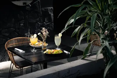 a black table with a plate of food and drinks on it at Porto Marina Hotel in Guatapé