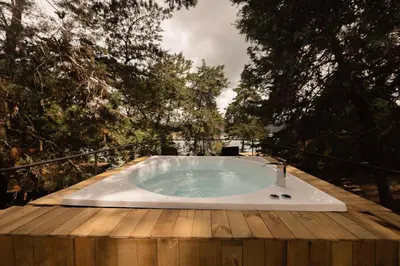 a hot tub sitting on top of a wooden deck at Porto Marina Hotel in Guatapé