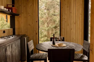 a table and chairs in a kitchen with a window at Porto Marina Hotel in Guatapé