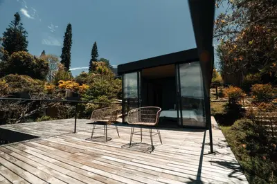 a house with two chairs on a wooden deck at Porto Marina Hotel in Guatapé