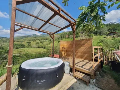 a jacuzzi tub sitting on a patio at Cabañas la tierra prometida in Cisneros