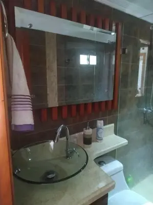 a bathroom with a sink and a mirror and a toilet at Hermoso apartamento totalmente amoblado in Medellín