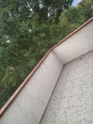 a brick wall with trees on top of it at Hermoso apartamento totalmente amoblado in Medellín