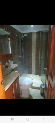 a bathroom with a shower and a toilet and a sink at Hermoso apartamento totalmente amoblado in Medellín