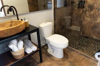 a bathroom with a toilet and a sink and a shower at GRETEL CHALETS SUIZO in Guatapé